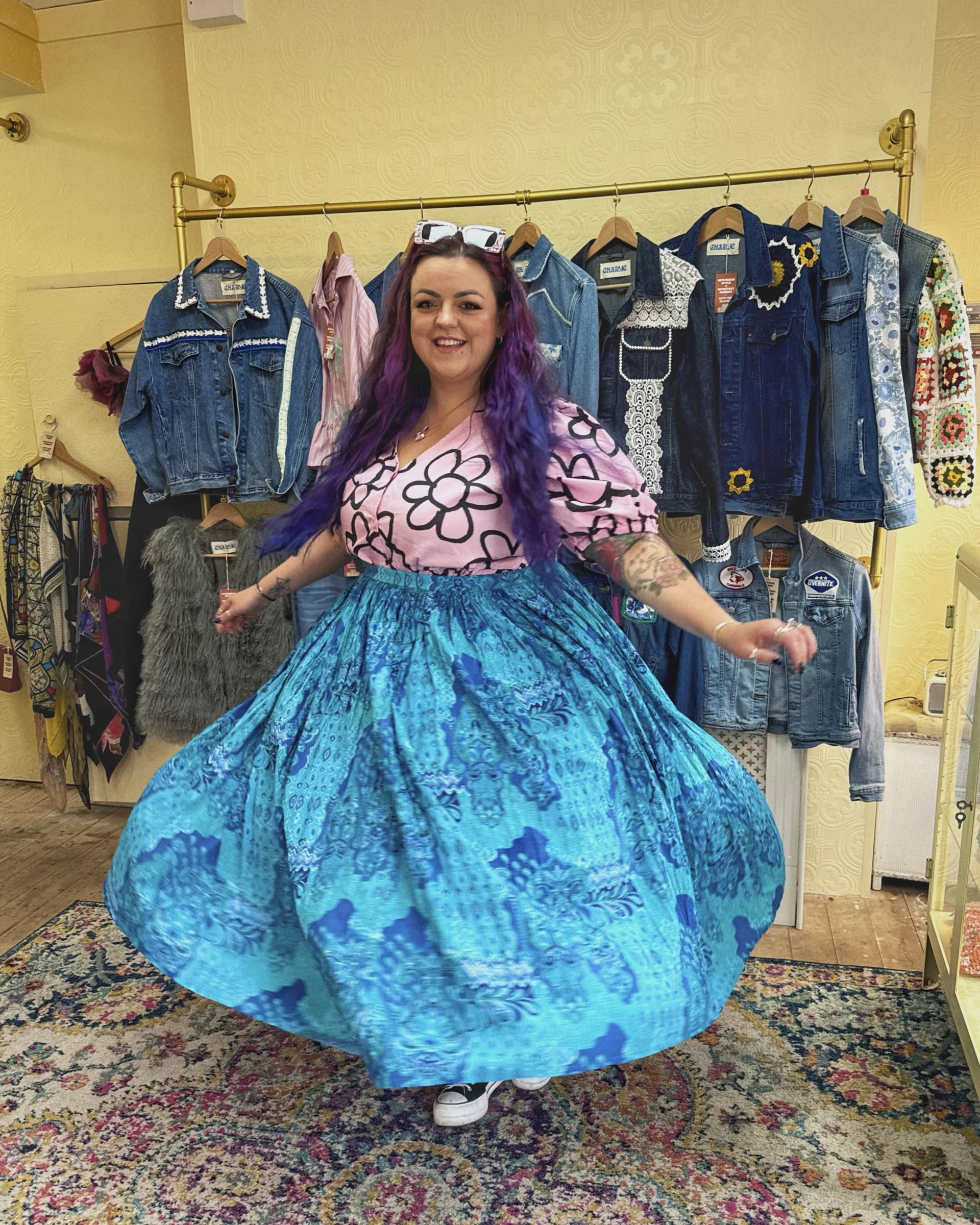 Luisa tries on a blue floaty skirt in the vintage boutique Greta Rae