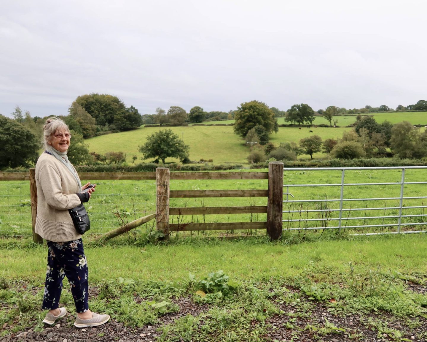 Luisa's mum looks out over the green hills outside the Silver Circle Distillery.