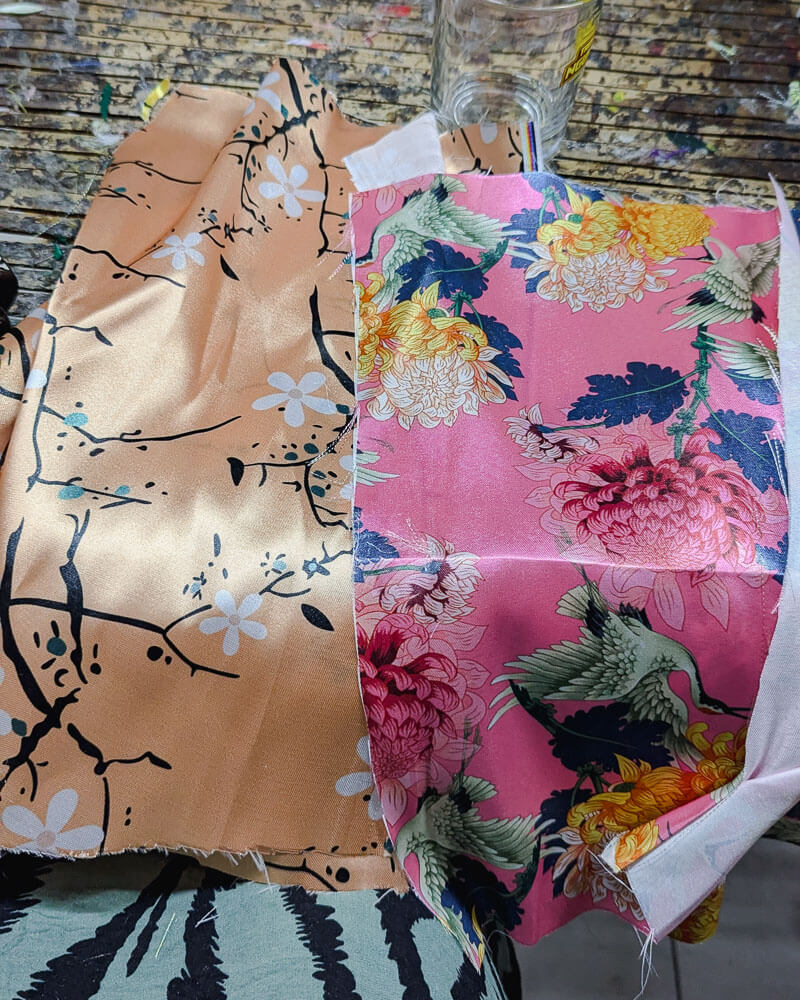 Two pieces of pink silk with floral design