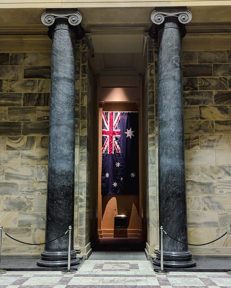 Australian flag hanging between two pillars at the Shrine of Rememberance